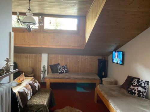 a room with a couch and a window and a tv at Monolocale Condominio Valleverde Fronte Piste in Sestriere