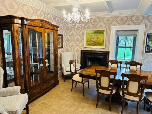 a dining room with a table and a chandelier at Glenastar Lodge in Newcastle West