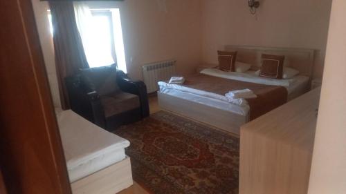 a small room with two beds and a window at Rubin Hotel in Goris