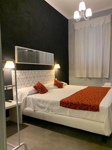 a bedroom with a large white bed with red pillows at Villa Giovanna Citylife Milano in Milan