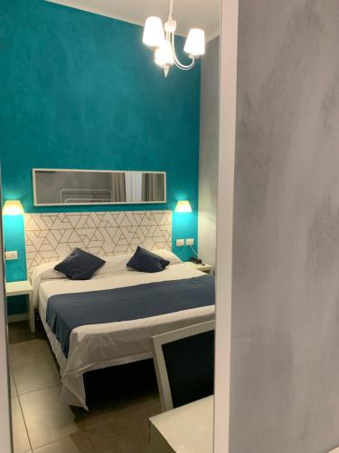 a bedroom with a bed and a blue wall at Villa Giovanna Citylife Milano in Milan
