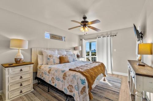 um quarto com uma cama e uma ventoinha de tecto em Big Blue Cottage 2A em Gulf Shores