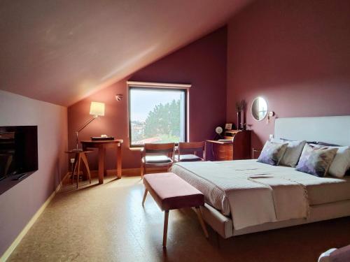 a bedroom with a large bed and a window at Guest house Eça Agora! in Vila do Conde