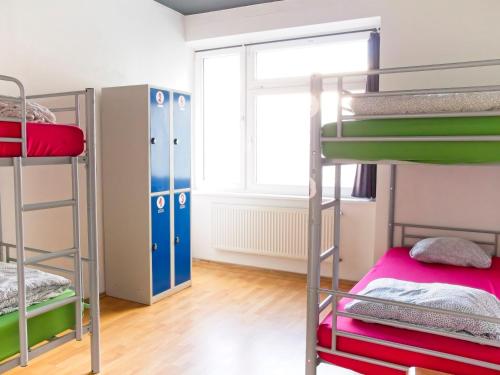 a room with bunk beds and a window at Urban Elephants Hostel in Bratislava