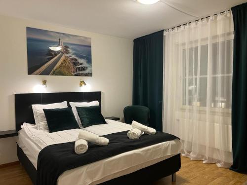 a bedroom with a large bed with towels on it at Hotell City Karlshamn in Karlshamn