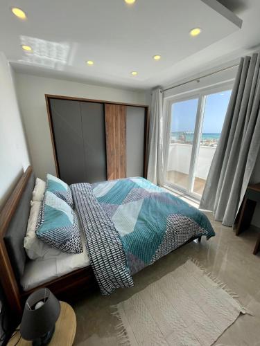 a bedroom with a bed with a view of the ocean at Axtart Penthouse with Amazing Views in Marsaxlokk