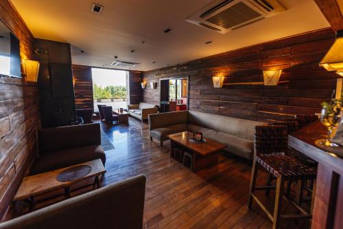 a living room with a couch and chairs and a table at Loi Suites Chapelco Hotel in San Martín de los Andes
