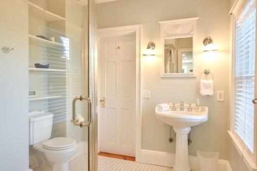 a white bathroom with a sink and a toilet at Ocean Views New A C Dog Welcome in Eastham