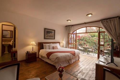 Postel nebo postele na pokoji v ubytování La Hostería Boutique Hotel