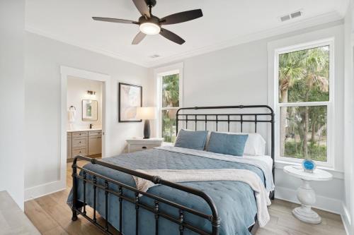 a bedroom with a bed and a ceiling fan at Champagne and Sunsets in Edisto Island