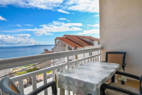 balcón con mesa y vistas al océano en Apartments Vinka en Trogir