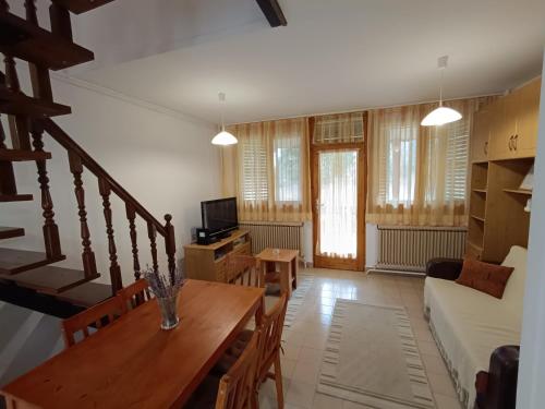 a living room with a table and a couch at SZEKI Apartman in Gyula