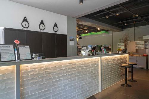 a bar in a restaurant with a counter and stools at BIG MAMA Berlin in Berlin