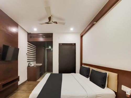 a bedroom with a bed and a flat screen tv at Collection O SRD Resort in Goa