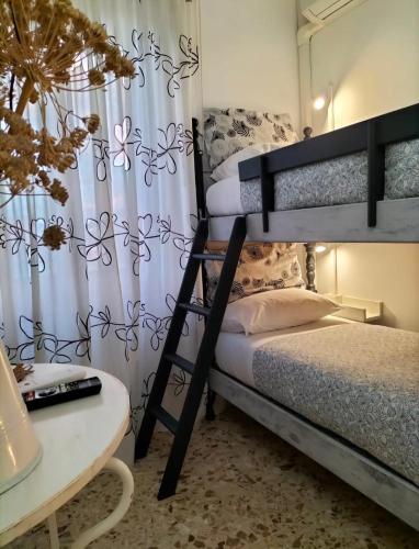 a bedroom with two bunk beds and a desk at Carru de ammentos in Ozieri