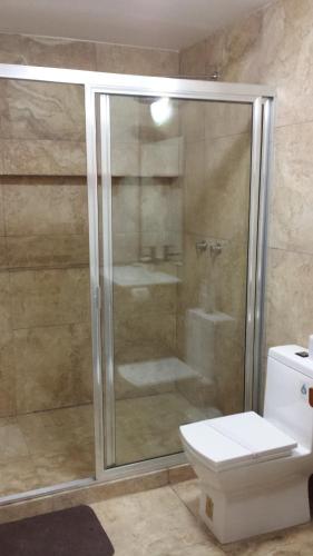 a shower stall in a bathroom with a toilet at Maya Vacanze Playa Natural in Playa del Carmen