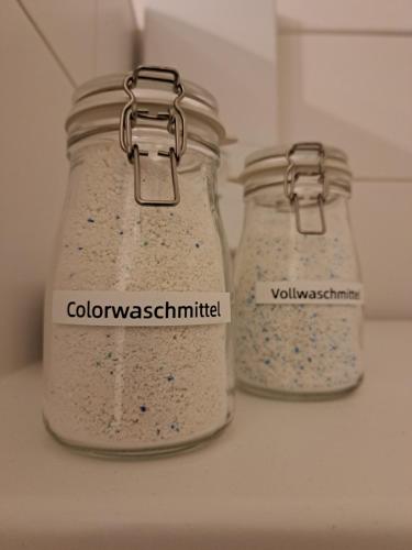 two mason jars filled with white oatmeal sitting on a counter at LIVORA Altstadt Wilhelmshaven - Stilvoll - Zentrumsnah - TV-Streaming - Balkon - Nordsee - Badewanne in Wilhelmshaven