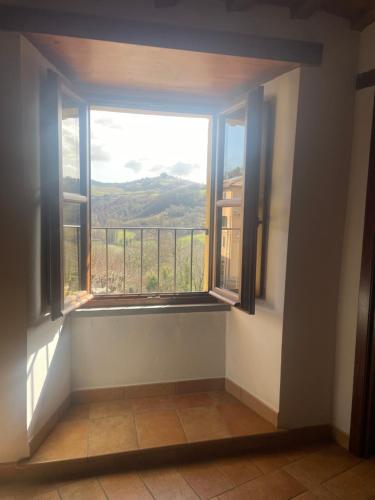 a room with a window with a view at LocAle Guest House in Pietralunga