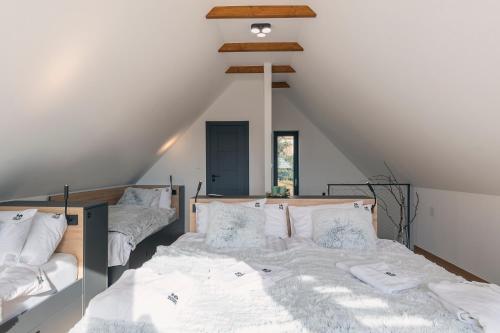 a bedroom with two beds in a attic at Mátra Zenit in Mátraszentimre