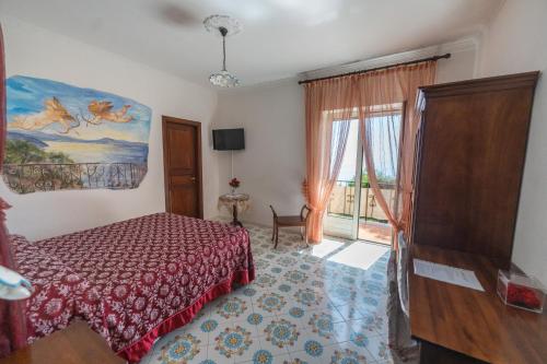 a bedroom with a bed and a large window at Nido Degli Dei in Agerola