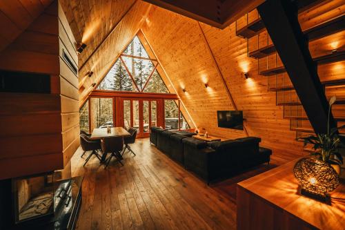 a living room with a couch and a table at The Cozy Chalet in Bosanski Petrovac