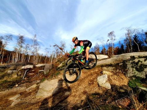 a man riding a bike on a rocky trail at Przystanek w kolorach świata in Jelenia Góra