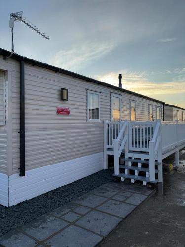 a large white building with a porch and a house at 3 bed Stunning caravan situated nr Whitstable in Whitstable