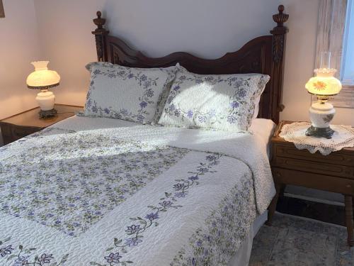 a bedroom with a bed with two lamps on tables at Bed & Breakfast private room and bath in Elkhart