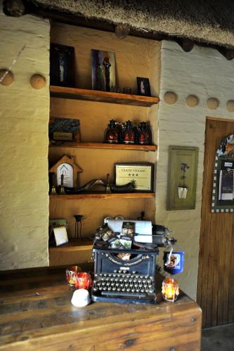 a room with an old typewriter on a wooden table at African Silhouette Guesthouse in Benoni