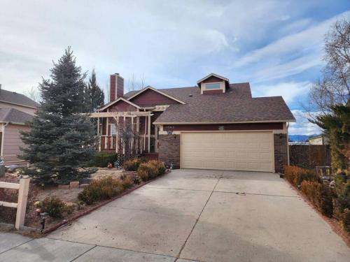 a house with a garage in front of it at Colorado Cottage W/Mountain View in Colorado Springs