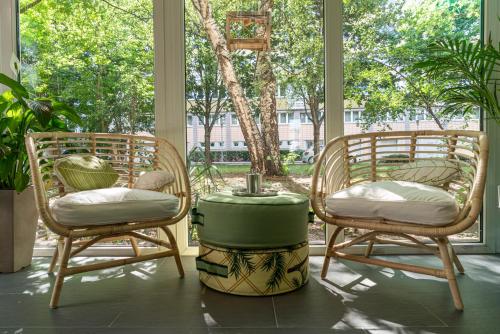 a porch with two chairs and a table in front of a window at BIG MAMA Leipzig in Leipzig