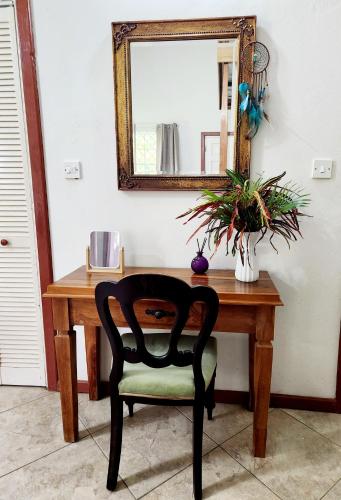 a desk with a chair and a mirror at Maison 79 in Soufrière