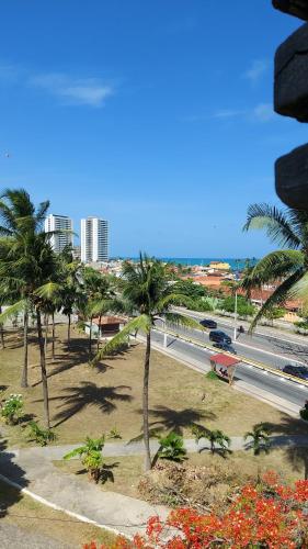 a view of a street with palm trees and a road at QUARTOS VISTA MAR COM PRIVACIDADE E BOA LOCALIZAÇÃO in Maceió
