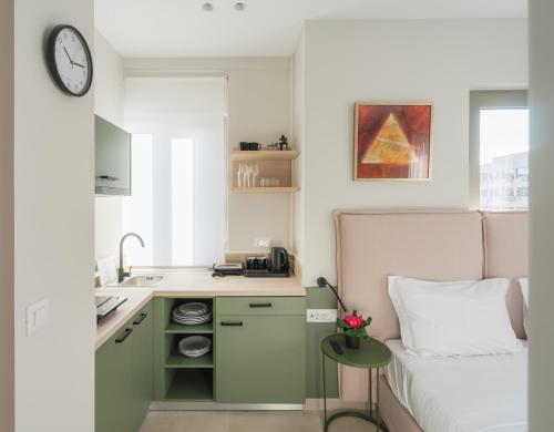 a small room with a bed and a kitchen at ELA FIVE RESIDENCES in Athens