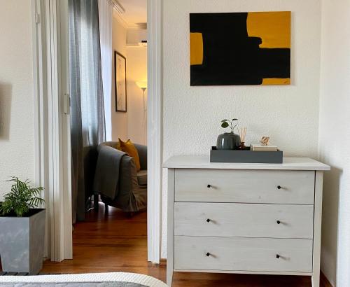 a white chest of drawers in a living room at NordiCasa in Eger