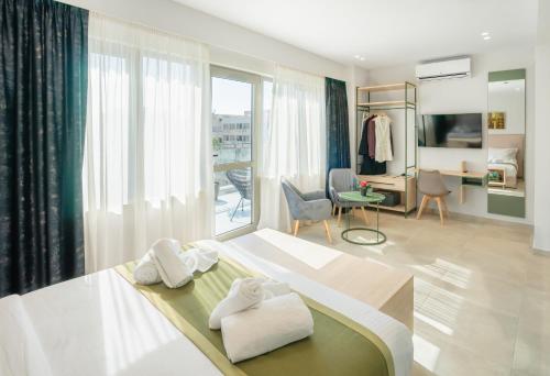 a bedroom with a bed with two towels on it at ELA FIVE RESIDENCES in Athens