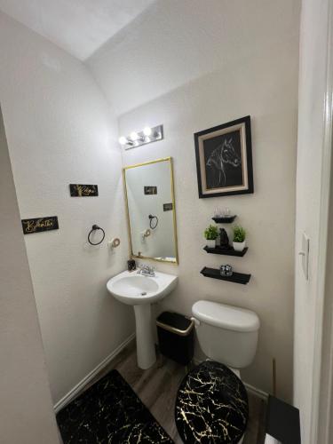 a bathroom with a white toilet and a sink at A Blissful Townhome with a Game Room Near AT&T Stadium, Six Flags, DFW Airport in Arlington