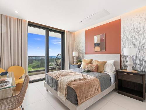 a bedroom with a bed and a large window at Fourteen at Mullet Bay in Cupecoy