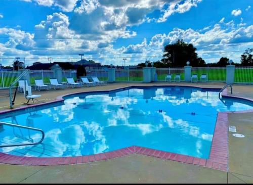 a large swimming pool with blue water at Hospitality House Union City I 69 US 51, TN in Union City