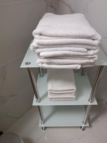 a stack of towels on a rack in a bathroom at Apartment Jolie in Interlaken