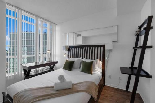 a bedroom with a large bed with a large window at Spacious 1BR - Downtown - Pool - Gym - Parking in Toronto