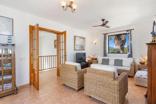 a living room with a couch and a tv at Villa Sea Garden Holidays in Port d'Addaia