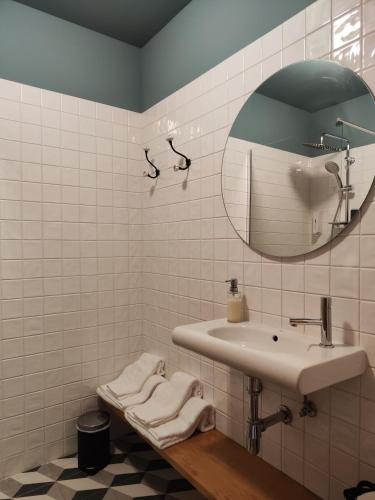 a bathroom with a sink and a mirror at Guest house Eça Agora! in Vila do Conde