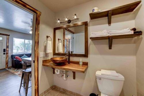 a bathroom with a sink and a toilet and a mirror at Angel Rock Rentals of Moab Unit 5 in Moab