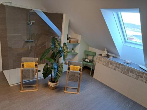 a bathroom with a shower and a plant and chairs at Apartment Martin 