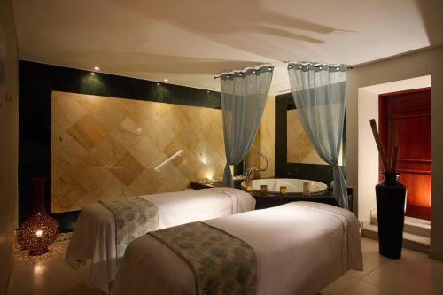 a hotel room with two beds and a tub at Bahia Principe Luxury Runaway Bay - Adults Only All Inclusive in Runaway Bay