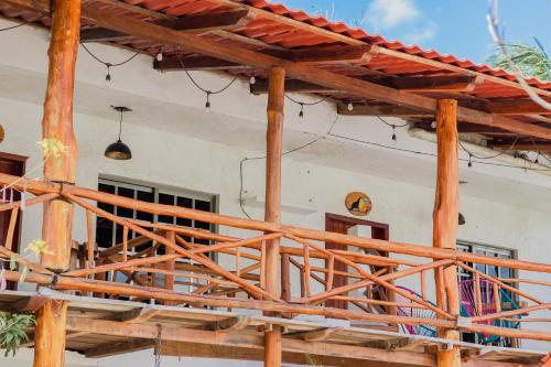 a wooden deck in front of a house at Hotel Szapot in Bacalar