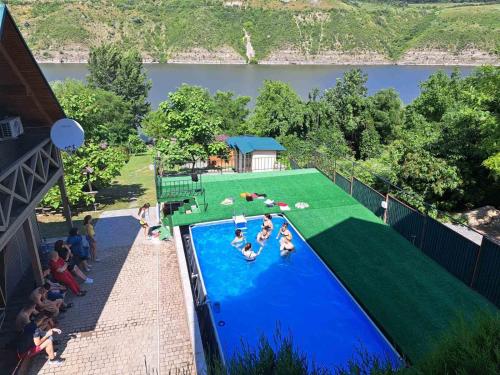 a group of people playing in a swimming pool at Family House in Makarovka