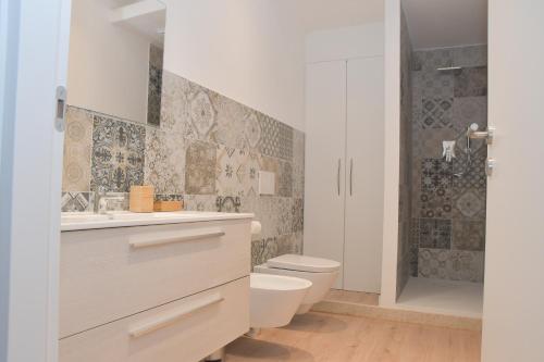 a bathroom with a toilet and a sink and a shower at Casa Ambra in Ancona