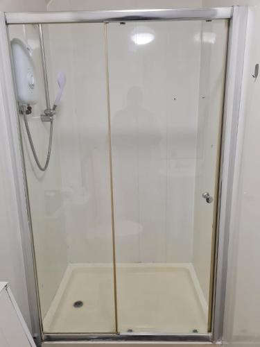 a shower with a glass door in a bathroom at Shortridge Terrace - 2 in Jesmond